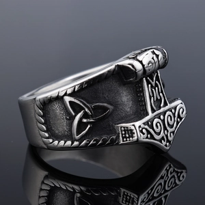 Vintage Thor's Hammer stainless steel ring with Celtic knots on reflective black background