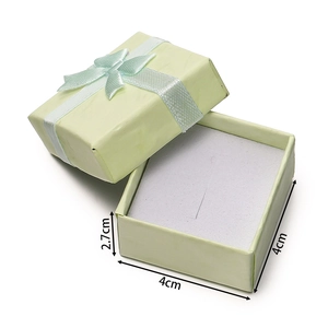 Detail of 4x4x2.7cm light green jewelry gift box with a white ribbon bow and foam insert
