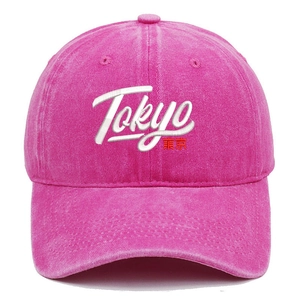 Detailed close-up of Tokyo embroidery on rose red washed cotton baseball cap