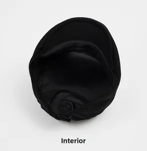 Detail view of cotton newsboy cap interior showing stitching and elastic closure