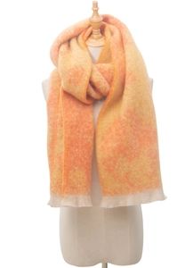 Detail of soft fuzzy texture and gradient fringe on a floral jacquard winter scarf