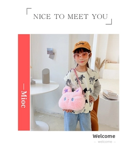 Detailed view of a plush pink rabbit-shaped crossbody bag worn by a young girl model