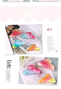 Detailed view of large gradient hair claws with starfish and seashell patterns