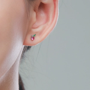 Minimalist S925 sterling silver apple stud earrings with red and green crystals on a model