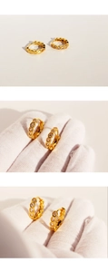 Detail showing hexagonal honeycomb golden earrings with inlaid cubic zirconia crystals