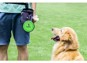 Outdoor pet training treat pouch with green collapsible silicone bowl on grass