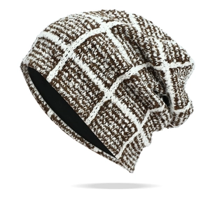 Close-up of brown and white checkered knit beanie with warm black inner lining