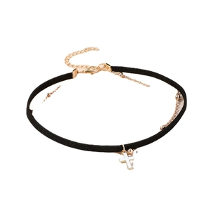 Minimalist black velvet choker necklace featuring a white cross pendant and gold clasp