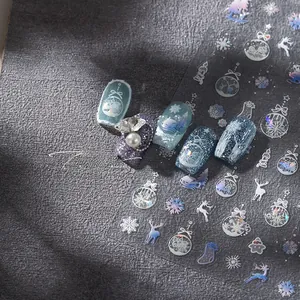 Detail of Christmas snowflake nail stickers with iridescent laser effects and winter motifs