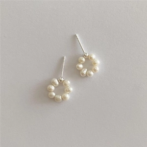 Detailed macro shot of white freshwater pearl wreath earrings with silver needles