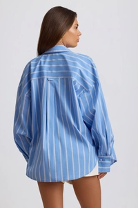 Detail view of oversized blue striped shirt with dropped shoulders and back pleat design