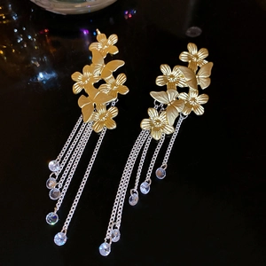 Detailed shot of vintage butterfly and floral earrings with silver tassel fringe