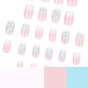 Short square press-on nails with pink gradient blue floral patterns and tiny pearl accents