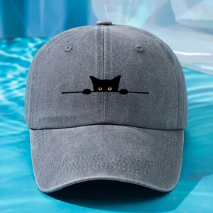 Close-up of cat embroidery on a grey washed cotton baseball cap with a wave-pattern background