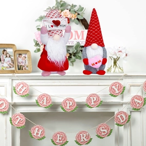 Detailed view of plush Mother's Day gnomes with heart and envelope on a white mantel