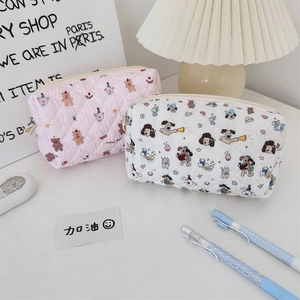 Detailed macro view of quilted pouches with cute cartoon bear and dog patterns