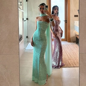 Detail of sequined tube long dresses in mint green and pink purple showing shiny texture