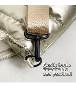 Detail of detachable plastic swivel hook and nylon strap on metallic puffer tote bag