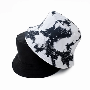 Close-up of black and tie-dye reversible bucket hat showing quality stitching details