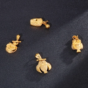 Detail view of four gold owl pendants showing intricate feather textures and craftsmanship