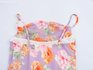 Detail view of purple floral chiffon dress featuring adjustable straps and hidden zipper