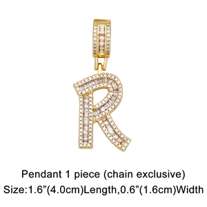 Close-up of gold R letter pendant with baguette and round cubic zirconia insets