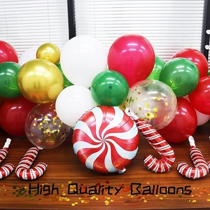 Close-up of high quality Christmas balloons in red, green, and gold on a wooden table