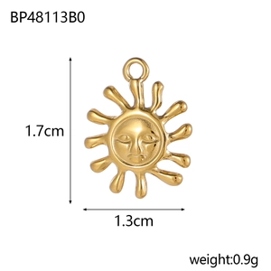 Macro view of gold sun pendant showing 1.7cm height and 1.3cm width dimensions