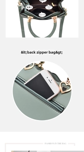 Detail view of mint green PU leather bag featuring multiple zipper compartments and heart charm