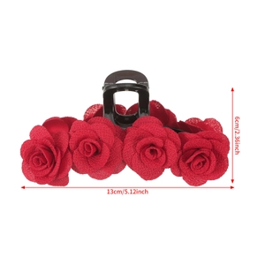 Red flocked rose hair claw clip for women's buns, measuring 13cm in length on white background