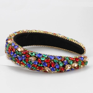 Macro detail of Baroque headband with colorful rhinestones and gold metal trim edges