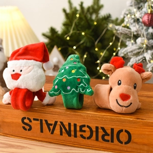 Christmas plush slap bracelets featuring Santa, Reindeer, and Tree on a rustic wooden box