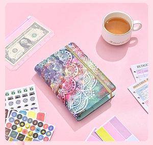 Close-up of A6 budget binder with mandala pattern, stickers and cash envelopes