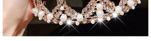 Macro shot of gold princess crown with detailed white pearls and sparkling rhinestones