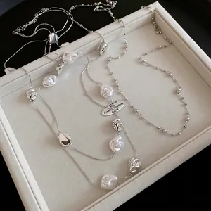 French vintage crystal beaded pearl necklace with silver metallic accents on velvet tray