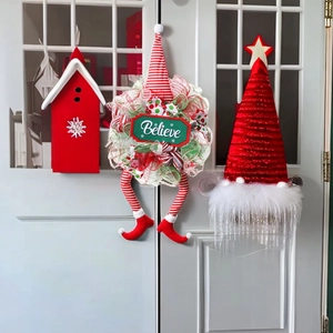 Christmas wreath with faceless gnome legs and Believe sign for festive door decoration