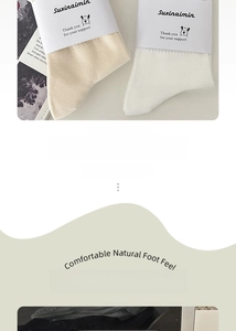 Detailed close-up of ribbed cuffs on cotton mid-calf socks in cream and white