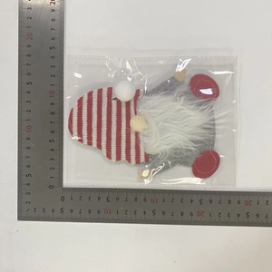 Detail of Christmas gnome cutlery bag showing 11x10cm size dimensions with a steel ruler