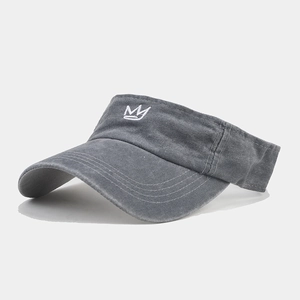 Detail of white crown embroidery on washed grey cotton canvas sun visor hat