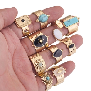 Detailed close-up of bohemian gold rings set featuring turquoise and various gemstones