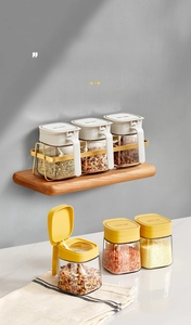 Glass seasoning jar set with airtight lids and wooden wall-mounted rack display