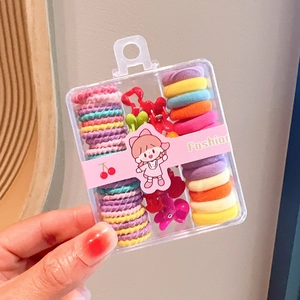 Close-up of colorful elastic hair ties and mini hair clips in a portable storage box