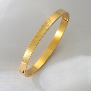 Elegant gold titanium steel bangle with etched wave pattern and secure buckle closure