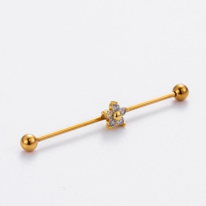 Close-up of golden stainless steel industrial barbell featuring a sparkling zircon flower
