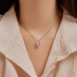 Close-up of S925 sterling silver necklace featuring pink and blue zircon geometric pendant