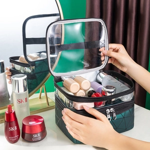 Double-layer dark green PU makeup bag with clear top and spacious interior storage