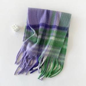 Close-up of soft purple and green checkered mohair scarf with long tassel textures
