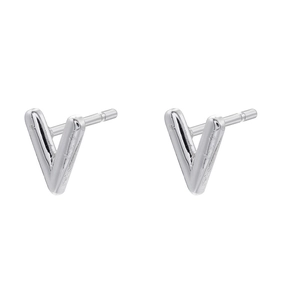 Macro detail of polished V-shaped silver stud earrings with minimalist metal texture