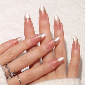 Cat eye almond press-on nails with champagne gold metallic French tip design