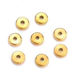 Close-up of eight gold-plated stainless steel spacer beads for DIY jewelry making